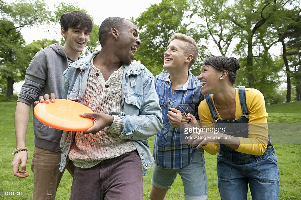 Young adults playing frisbee in the park